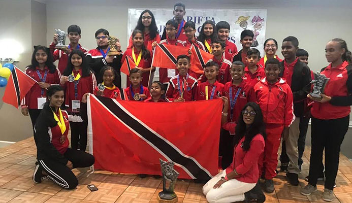 TT’s chess team display their medals and trophies after competing at the Carifta Chess Championships, in Curacoa, on the Easter weekend.